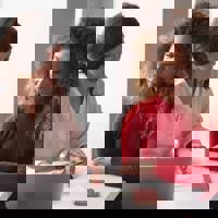 2 Women at a desk discussing something on a paper