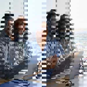 Man and woman discussing information on a laptop