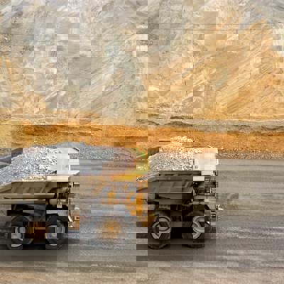 Truck full of rubble driving through gold mine