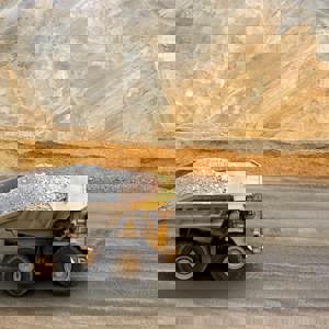 Truck full of rubble driving through gold mine