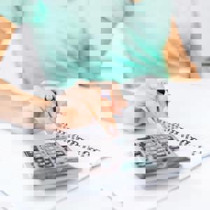 Woman using calculator