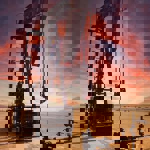 Oil refinery in desert at sunset