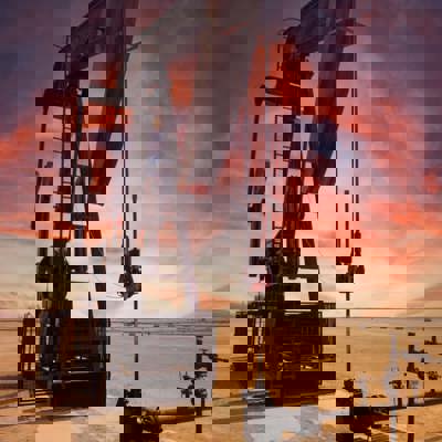Oil refinery in desert at sunset